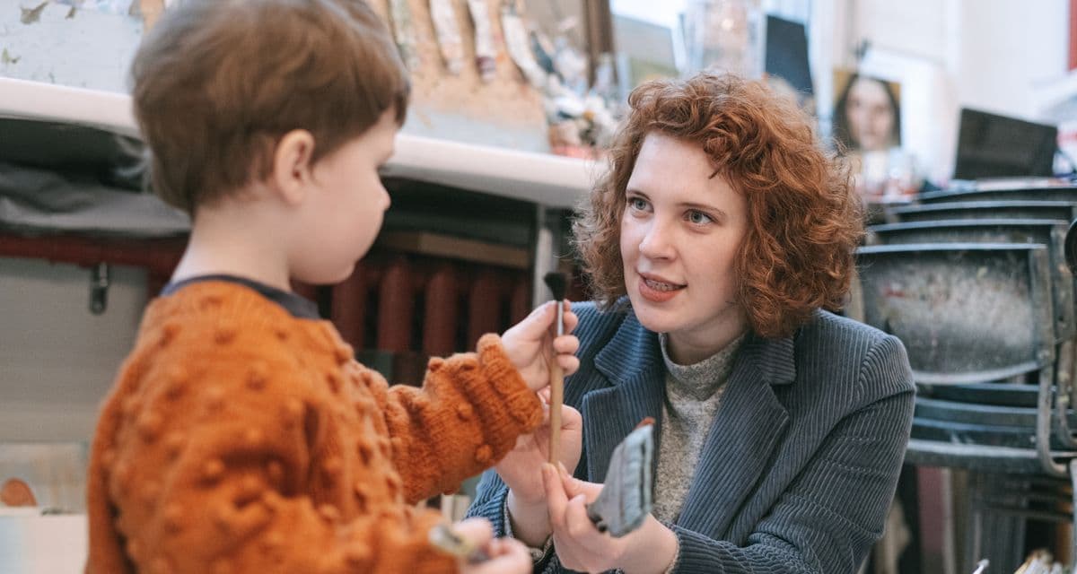 Educator talking warmly with a parent at pickup time